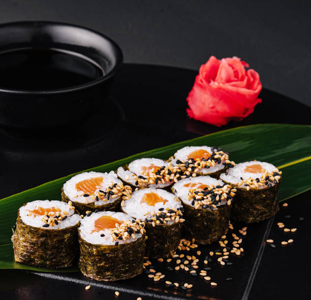 istock Sushi Rolls Set with Salmon on black plate 1545032065