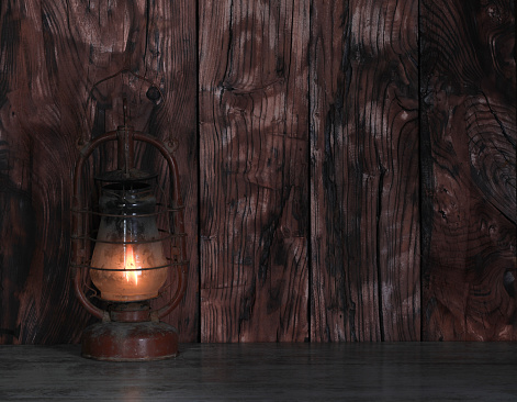 old dirty kerosene lamp on a wooden table