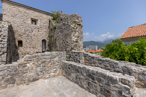 Budva, Montenegro - June 28, 2023: Medieval fortress of St. Mary, also known as the Citadel. Fragment of the defensive stone City Walls surrounding old town
