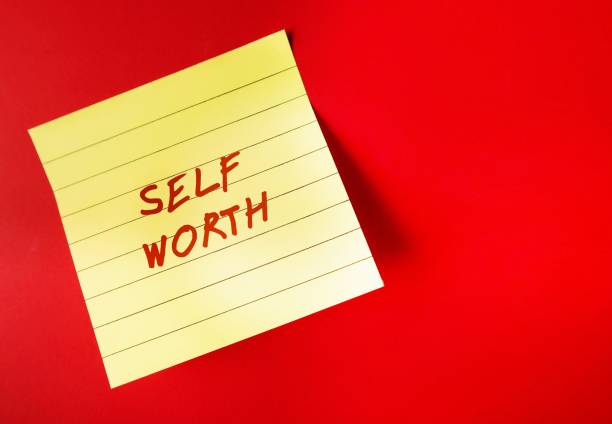 istock Yellow paper note on red background with handwritten text SELF WORTH, refers to self-love, being confidence with self-esteem - giving yourself respect, dignity and understanding 1545086881