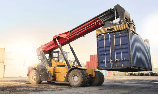 istock Transport, logistics and supply chain with container storage and a crane vehicle on a commercial dock. Shipping, cargo and freight in an empty yard for export, import and delivery of goods or service 1545098142