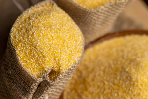Dry corn flour poured into a linen bag for making porridge, high-quality corn flour from corn grains in a bag