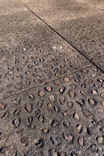 istock concrete walking path with natural stones 1545103195