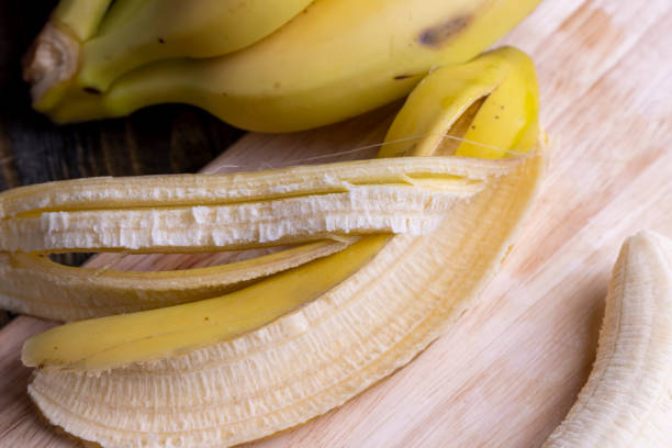 istock Peeled old ripe banana on the board 1545104122