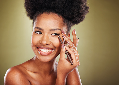 Black woman, makeup and eyeliner eye pencil for cosmetics beauty product, healthy self care and cosmetic self love. Face of happy African model, skincare health and smile on a brown studio background