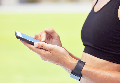 Fitness woman, phone app and sports woman outside for exercise, training and a workout for health and fitness. Closeup hands of active female athlete tracking progress for cardio steps and wellness