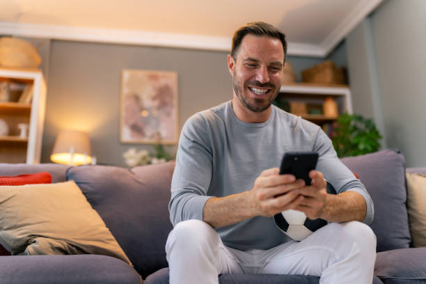 istock Watching soccer game at home 1545162004