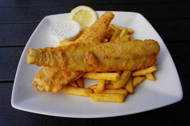 istock Fish and chips is a hot dish consisting of fried fish in batter, served with chips. 1545190438