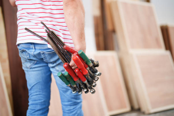 istock Man holding a stack of clamps 1545198495