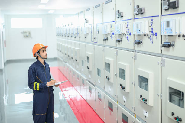 istock Asian electrical technician worker with personal safety equipment working and checking status from control panel switch board in control room of high voltage electric transformer station. Industrial business occupation worker concept. 1545224687