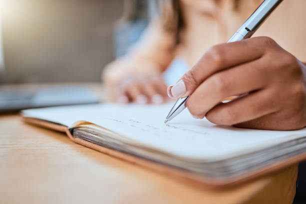 istock Schedule, writing and zoom of hand with notebook for planning, inspiration and creative ideas. Freelance career, information and busy woman working on calendar plans, strategy and journal report 1545265030