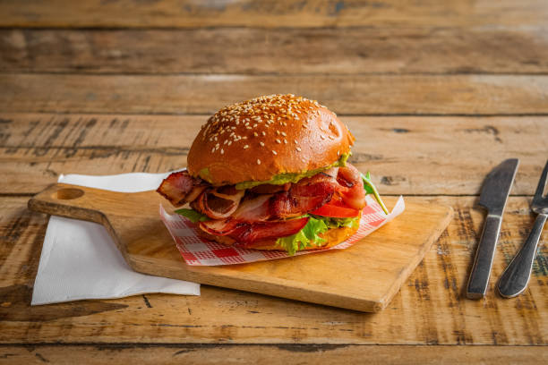 Homemade burger with bacon, lettuce and tomato