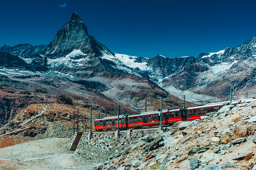 Train in high Alps mountains on Matterhorn background
