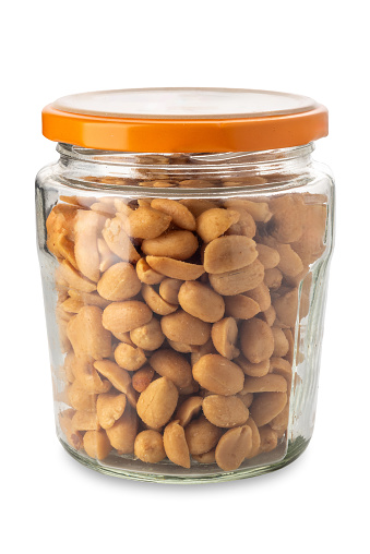 Peanuts in glass jar isolated on white with clipping path included