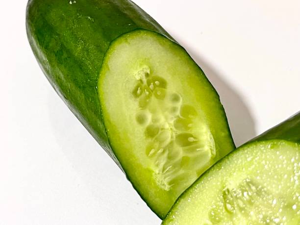 istock Sliced ​​fresh cucumber on white background 1545310485