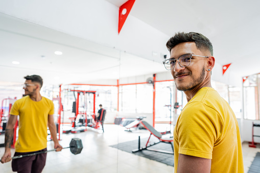 Portrait of a young man exercising in the gym