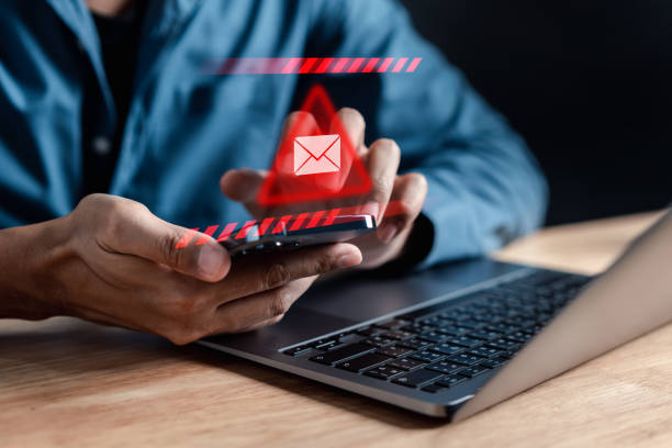 istock Alert Email inbox and spam virus with warning caution for notification on internet letter security protect, junk and trash mail and compromised information. 1545325094