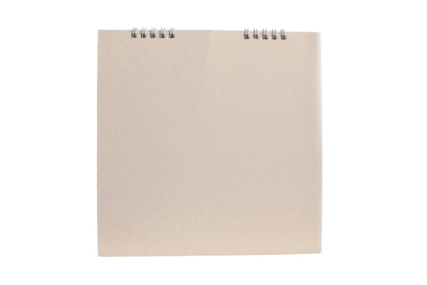istock Brown blank paper desk spiral calendar on white background. 1545344325