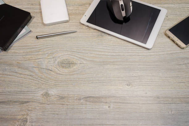 Copyspace of smart phone tablet and computer devices pen with wood top table