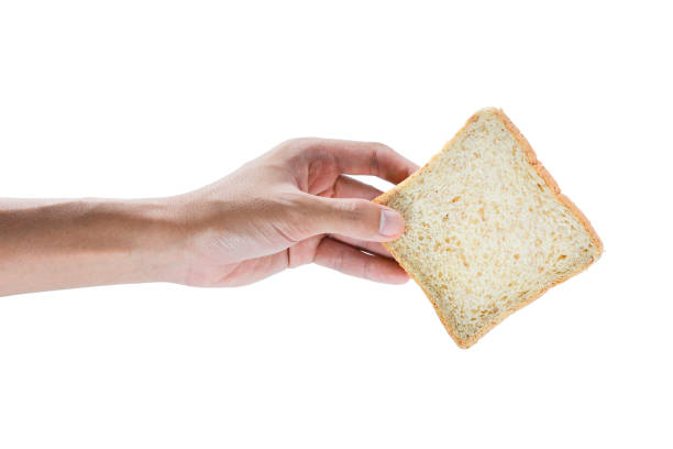 istock The hand holding Whole wheat bread isolated on white background. 1545346429