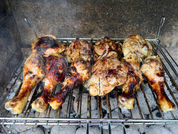 istock Appetizing fried, roasted chicken legs, thighs on the hot barbecue ( B-B-Q) grill 1545353696