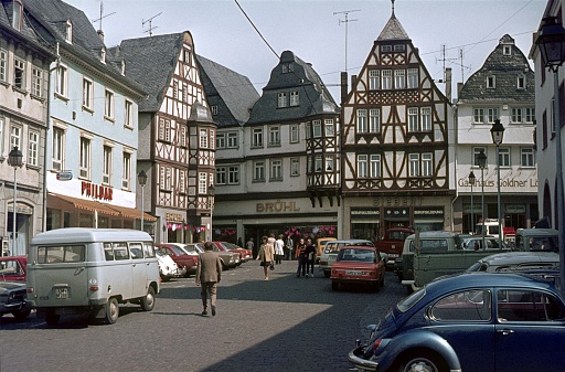 Limburg an der Lahn, Hesse, Germany, 1976. Market square in the medieval old town of Limburg an der Lahn. Furthermore: Half-timbered houses, parked cars, shops and locals.