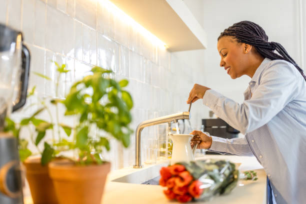 Smiling afro-american woman is making a bouquet at home