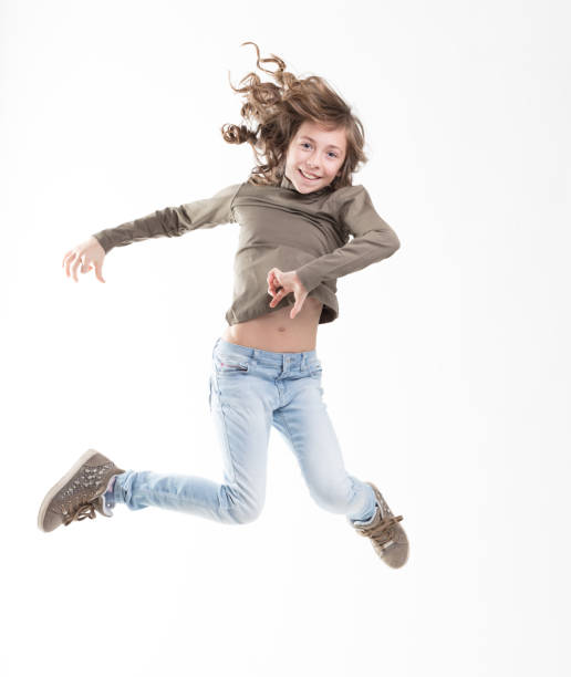Flying girl in green, jeans, white background