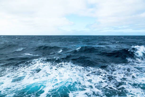 istock Ocean water background with foam. Ocean water splash. Not a calm 1545396054