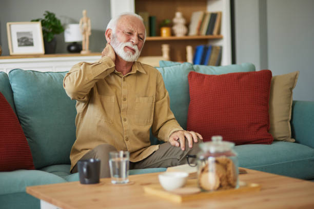 istock Senior man feeling exhausted and suffering from neck pain 1545399234