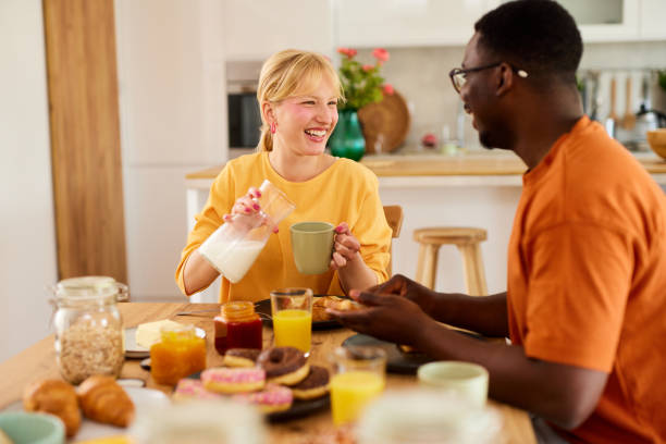 istock Multiracial couple enjoying breakfast together at home 1545399809