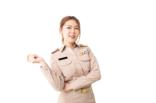 Female Thai government officer in khaki uniforms smiling on white background. Happy asian woman posing with crossed arms and looking at camera and copy space. Confident girl get happy and feel relax.