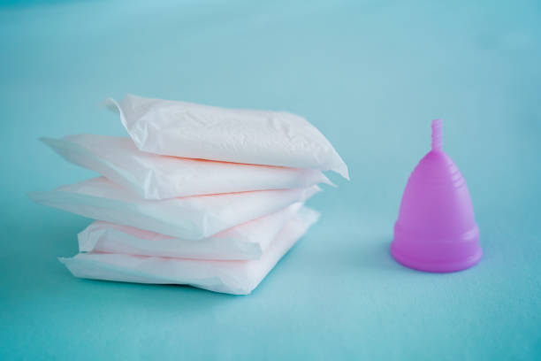 istock Menstrual cup and pads on a blue background, concept of critical days 1545429937
