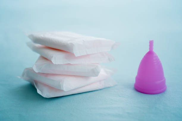 istock Menstrual cup and pads on a blue background, concept of critical days 1545431621