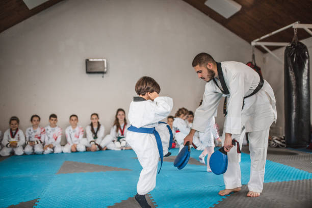 istock A toddler practices taekwondo with his martial arts trainer 1545436254