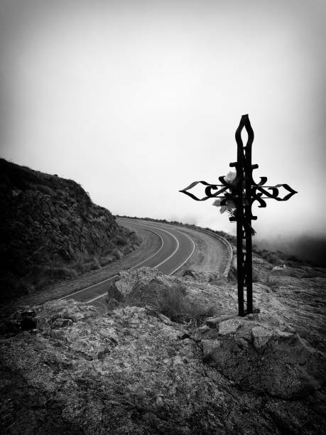 istock Cross on a rock overlooking the road 1545463712