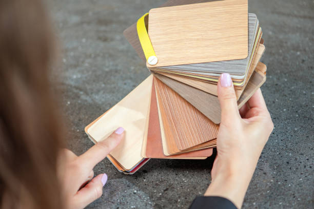 istock laminate samples. The choice of laminated surface for chipboard. Samples of wood imitation laminate in hands, close-up. 1545474678