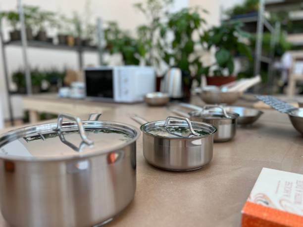 istock Selection of saucepans on a table 1545485482