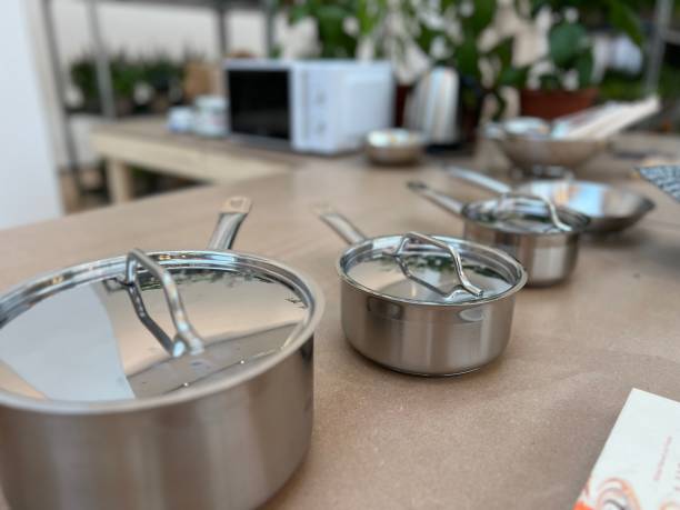 istock Selection of saucepans on a table 1545485865