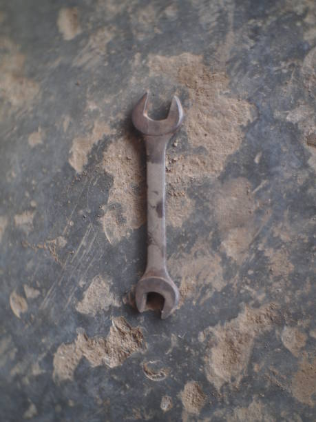 istock Wrench on a dirty floor 1545493222