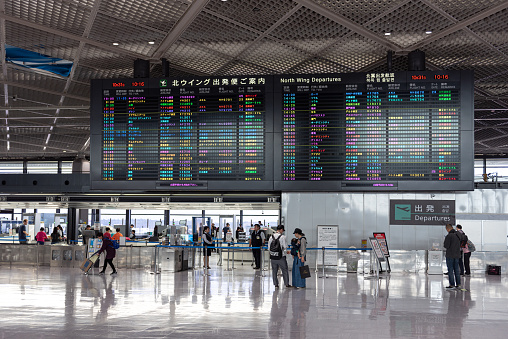 Tokyo, Japan - October 31, 2019: Narita International Airport with Screen and People in Background.