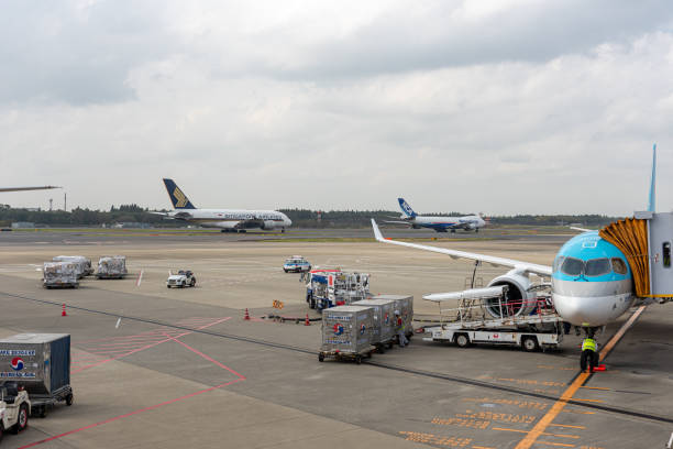 Narita International Airport with Runway and Airplanes in Background. Narita, Japan - October 31, 2019: Narita International Airport with Runway and Airplanes in Background. nippon cargo airlines photos stock pictures, royalty-free photos & images