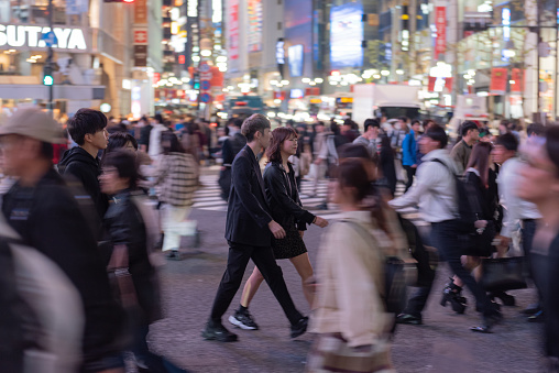 Tokyo, Japan - October 30, 2019: Shibuya Crossing in Tokyo, Japan. The most famous intersection in the world. Blurry because of the panning.
