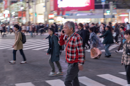 Tokyo, Japan - October 30, 2019: Shibuya Crossing in Tokyo, Japan. The most famous intersection in the world. Blurry because of the panning.