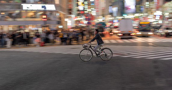 Tokyo, Japan - October 30, 2019: Shibuya Crossing in Tokyo, Japan. The most famous intersection in the world. Blurry because of the panning.