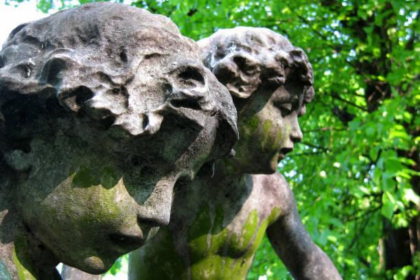 Close-up on a couple of cherubim statues at Brompton Cemetery in London, UK.