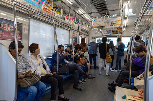 Tokyo, Japan - October 30, 2019: Tokyo Metro Train and People sitting in the car. Seibu Shinjuku Station