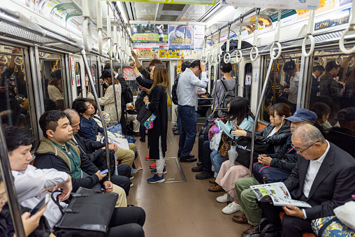 Tokyo, Japan - October 25, 2019: Tokyo Metro Train and Car Full of People. Going Home after Work Day