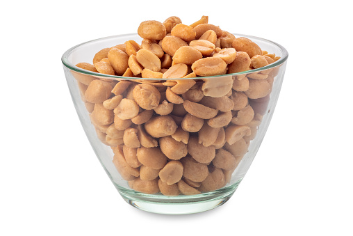 Peanuts in glass cup isolated on white with clipping path included