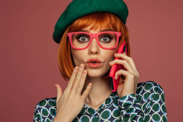 istock Beautiful emotional woman using phone 1545652482